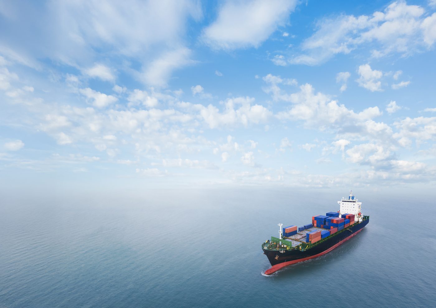 Container ship sailing on a calm blue sea